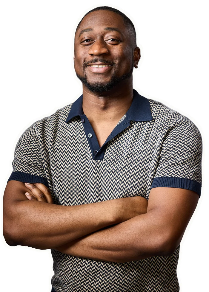 Julian McKenzie smiling with his arms crossed.